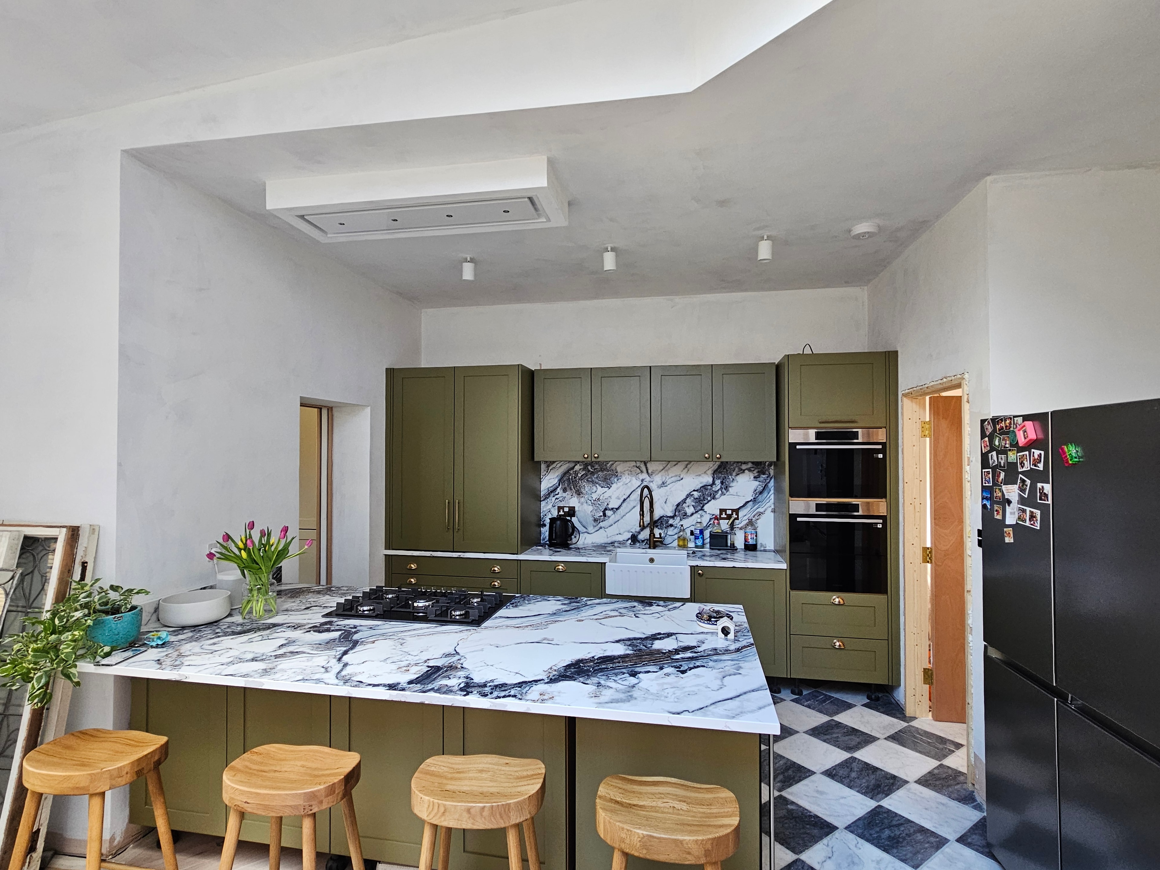 Kitchen largely complete with bar stools