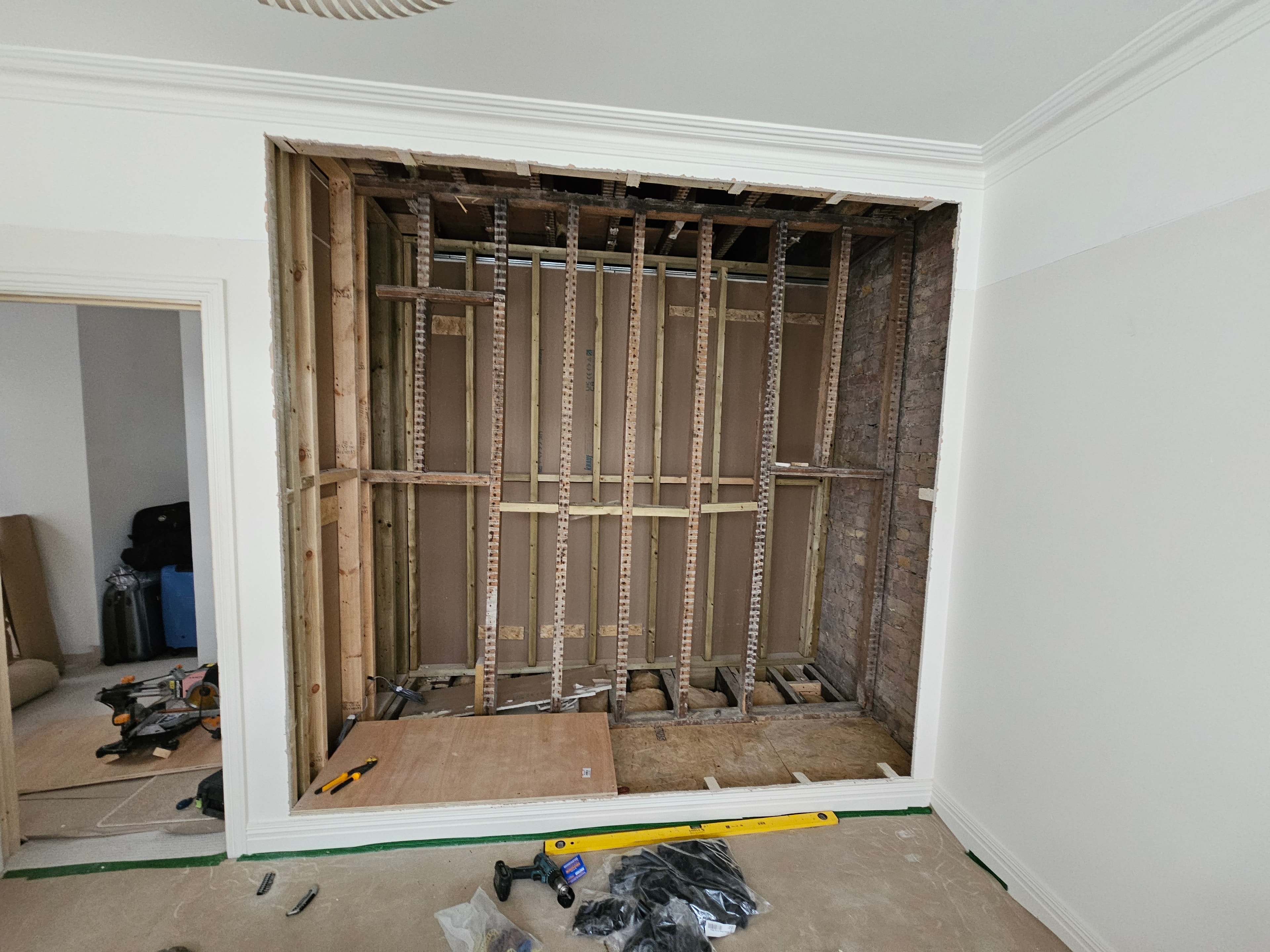 Stud framing and brick wall exposed